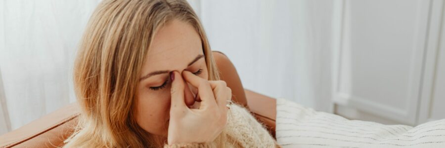 a female suffering from sinus pressure due to sinusitis